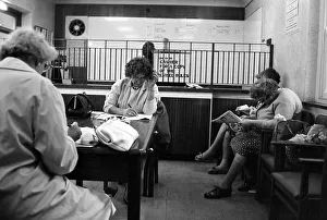 Four ladies studying the form guide before placing their bets at a Ladies only betting Four ladies studying the form guide before placing their bets at a Ladies only betting