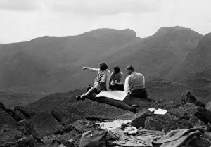 Lakeland hikers on top of Bowfell admire the grandeur of Scafell Lakeland hikers on top of Bowfell admire the grandeur of Scafell