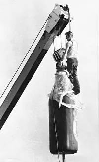 A very large bootle of beer being airlifted A very large bootle of beer being airlifted