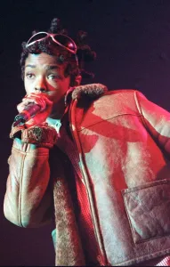 Lauryn Hill 1996 singer with the pop group The Fugees holding microphone in hand up Lauryn Hill 1996 singer with the pop group The Fugees holding microphone in hand up
