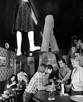 Legs coming through the roof a local pub as customers order more drinks from the bar Legs coming through the roof a local pub as customers order more drinks from the bar