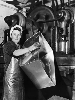 Lily Hill at her giant press stamping out the metal foundations of baby prams at a Lily Hill at her giant press stamping out the metal foundations of baby prams at a