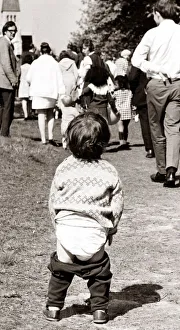 Little child showing off his nappies. Circa 1950 Little child showing off his nappies. Circa 1950