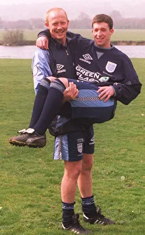 Liverpool defender Mark Wright carries his fellow club teammate Robbie Fowler in his Liverpool defender Mark Wright carries his fellow club teammate Robbie Fowler in his