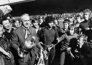 Liverpool manager Bill Shankly celebrates with the League Championship trophy as his side Liverpool manager Bill Shankly celebrates with the League Championship trophy as his side