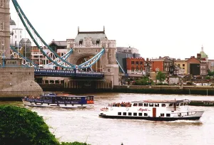 London Tourists on River Buses pass under Tower Bridge London Tourists on River Buses pass under Tower Bridge