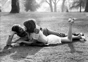Love and romance A couple lie entwined on a man's coat in the park, May 1971 Love and romance A couple lie entwined on a man's coat in the park, May 1971