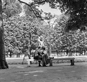 Lovers kiss in a Paris park by a statue during the 1958 state of emegency Lovers kiss in a Paris park by a statue during the 1958 state of emegency