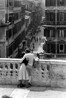 Loving couple look down over a street in the city of Rome, Italy April 1975 Loving couple look down over a street in the city of Rome, Italy April 1975