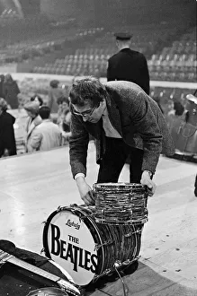 Mal Evans dismantles Ringo Starr's drum kit after the concert in Washington DC during Mal Evans dismantles Ringo Starr's drum kit after the concert in Washington DC during