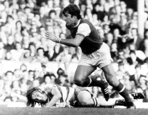 Malcolm MacDonald of Arsenal leaves Stan Bowles of Queens Park Rangers on the floor Malcolm MacDonald of Arsenal leaves Stan Bowles of Queens Park Rangers on the floor