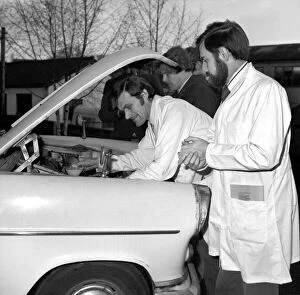 Images Dated 14th February 1974: Man / Car / Unusual / Humour. Car at I. P. C. Hemel Hempstead car examiner