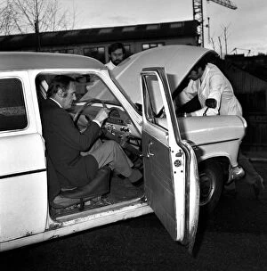 Images Dated 14th February 1974: Man / Car / Unusual / Humour. Car at I. P. C. Hemel Hempstead car examiner