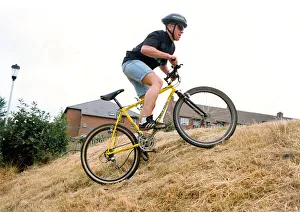 A man on his Diablo mountain bike climbing hills A man on his Diablo mountain bike climbing hills