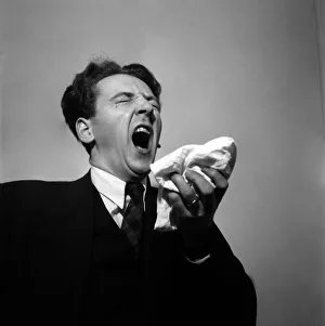Man holding his handkerchief while sneezing. October 1952 C4925-001 Man holding his handkerchief while sneezing. October 1952 C4925-001