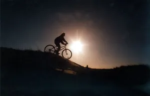 A man riding his mountain bike cross country A man riding his mountain bike cross country