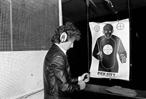 Images Dated 15th June 1980: A man shooting at a target during practice at Gun City shooting range in South Africa