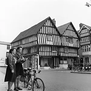 Man and woman sightseeing in an English town with Tudor style houses. October 1952 C5252 Man and woman sightseeing in an English town with Tudor style houses. October 1952 C5252
