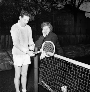 Man and woman talking after enjoying a game of tennis January 1953 D500 Man and woman talking after enjoying a game of tennis January 1953 D500
