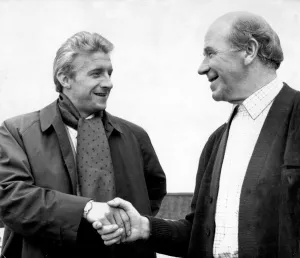 Manchester United footballer Denis Law shakes hands with his manager Matt Busby at Old Manchester United footballer Denis Law shakes hands with his manager Matt Busby at Old