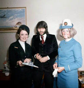 Manchester United footballer George Best with air hostesses before boarding his plane Manchester United footballer George Best with air hostesses before boarding his plane