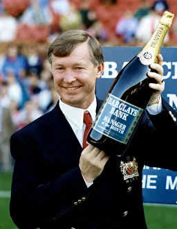Manchester United manager Alex Ferguson holding a bottle of champagne Manchester United manager Alex Ferguson holding a bottle of champagne