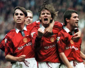 Manchester United Player David Beckham celebrates with team mates Gary Neville (left Manchester United Player David Beckham celebrates with team mates Gary Neville (left