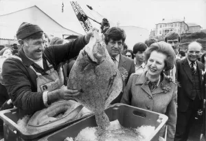 MARGARET THATCHER IS SHOWN A LARGE TURBOT BY LIFEBOAT MECHANIC EDDIE MURT IN PADSTOW MARGARET THATCHER IS SHOWN A LARGE TURBOT BY LIFEBOAT MECHANIC EDDIE MURT IN PADSTOW
