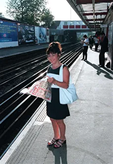 Maria Smedley actress reading copy of Daily Mirror Newspaper while standing Maria Smedley actress reading copy of Daily Mirror Newspaper while standing