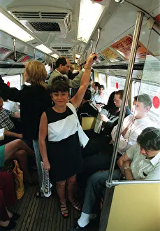 Maria Smedley actress standing on underground train holding on to hand rail Maria Smedley actress standing on underground train holding on to hand rail