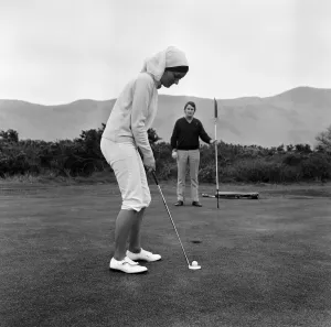 Marion Jones, 22, who took up golf a few weeks ago. She cut down a pair of slacks to Marion Jones, 22, who took up golf a few weeks ago. She cut down a pair of slacks to
