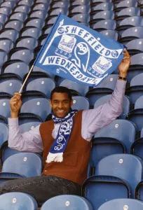 Mark Bright footballer for Sheffield Wednesday sits in seats and waves a flag Mark Bright footballer for Sheffield Wednesday sits in seats and waves a flag