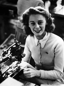 Mayme Bell Sewing machinist putting buttons onto golf cardigan knitware worker factory Mayme Bell Sewing machinist putting buttons onto golf cardigan knitware worker factory