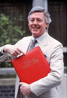 Michael Aspel TV Presenter of this is your life holding red book Michael Aspel TV Presenter of this is your life holding red book