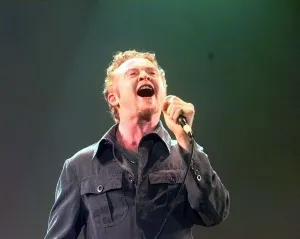 Mick Hucknall of Simply Red performing at Warwick Castle. August 1999 Mick Hucknall of Simply Red performing at Warwick Castle. August 1999