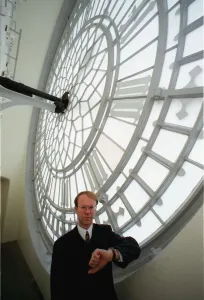 Mike McCann Keeper of the Great Clock December 1999, standing behind the face of Mike McCann Keeper of the Great Clock December 1999, standing behind the face of