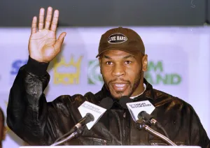 Mike Tyson waves during the head to head press Conference for the Heavyweight World Title Mike Tyson waves during the head to head press Conference for the Heavyweight World Title
