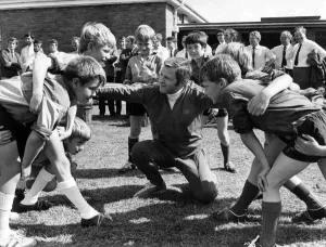 A mini scrum about to form as WRU coaching organiser Ray Williams talks to pupils A mini scrum about to form as WRU coaching organiser Ray Williams talks to pupils