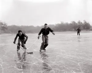 00007 Prints: 1950s Winter Print: Two Boys Playing Ice Hockey on a Frozen Lake