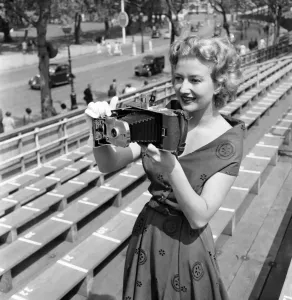 00008 Prints: Print of a woman checking a Polaroid camera near Hyde Park Corner