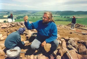 00009 Prints: Durham University Archaeologist at Breamish Valley Burial Site Print