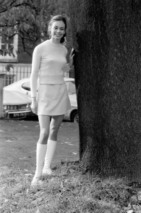 Fashion In The 60s Prints: Woman wearing matching top, mini skirt and knee high looks poses for pictures