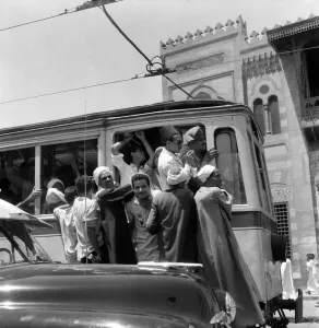 00037 Prints: Egypt: Print of a crowded tram with people hanging around it, August 1953