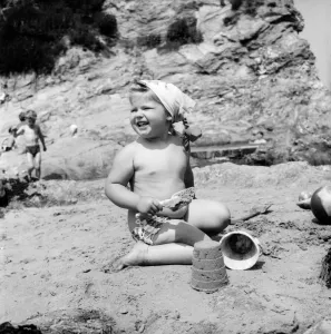00038 Prints: A 3-year-old girl in pigtails builds sandcastles on Porth Towan Beach