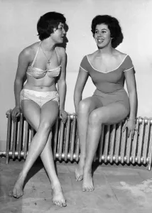Retro Swimwear Designs Prints: Strip Freeze. Models Verna Clarke and Thelma Drabble were happy to find this warm spot