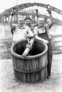 Prints of Coopers Paddy McGeever (left) and Jacky Webster (right) and fitter bobby Adamson celebrate the completion of their dolly tub which will go on show in a County Durham mining museum County Durham Prints: Coopers Paddy McGeever and Jacky Webster Print