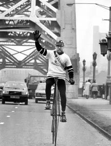 00078 Prints: John Pinkerton Rides a Penny Farthing Across the Tyne Bridge Print