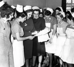 00079 Prints: Black and white print of a group of nurses in discussion