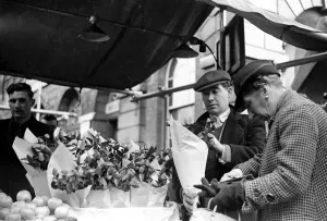 00081 Prints: Print of a flower seller serving a customer at Kingston market, circa 1936