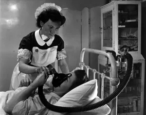00097 Prints: Print of an expectant mother using an inhaler during labour